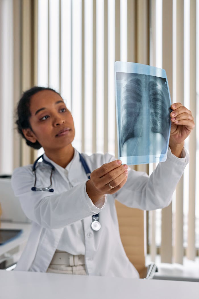 A doctor examines a chest x-ray for diagnosis in a clinical setting.